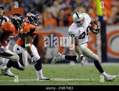 Oakland Raiders running backs Darren McFadden, left, and Rock Cartwright,  right, rest between drills during their NFL football training camp in Napa,  Calif., Thursday, July 28, 2011. (AP Photo/Eric Risberg Stock Photo 