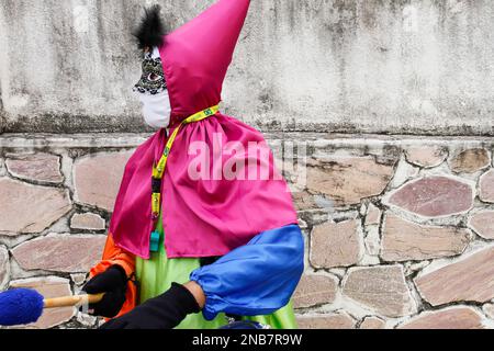 Minas Gerais, Brazil - March 4, 2019: masqueraders known as cainaguas wearing their characteristic colorful clothes on the streets during carnival in Stock Photo