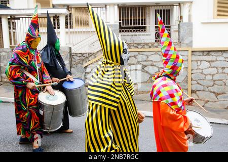 Minas Gerais, Brazil - March 4, 2019: masqueraders known as cainaguas wearing their characteristic colorful clothes on the streets during carnival in Stock Photo
