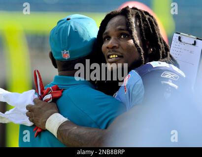 Tennessee Titans running back Chris Johnson, right, hugs Seattle Seahawks' T.J.  Houshmandzadeh after the Titans won 17-13 Sunday, Jan. 3, 2010, in an NFL  football game in Seattle. On Sunday, Johnson became