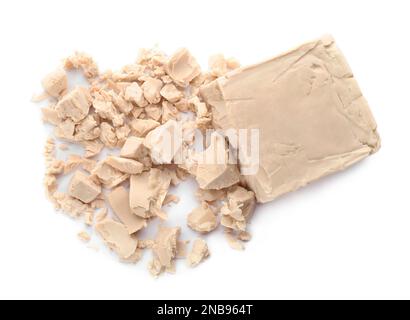 Crumbled block of compressed yeast on white background, top view Stock Photo