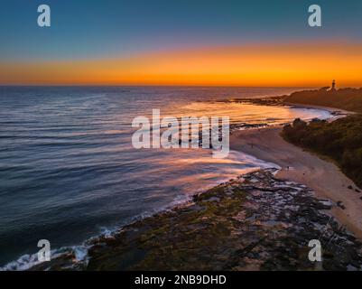 Aerial sunrise seascape from the sheltered bay of Cabbage Tree Harbour at Norah Head, NSW, Australia. Stock Photo