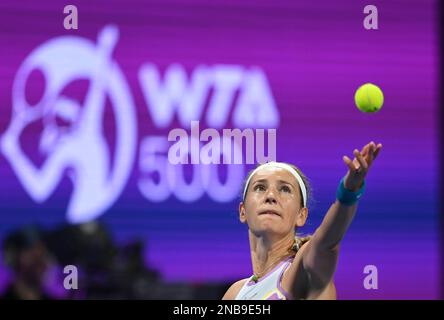 Doha, Qatar. 13th Feb, 2023. Victoria Azarenka of Belarus serves during the singles round of 32 match against Ipek Oz of Turkey at WTA500 Qatar Open 2023 in Doha, Qatar, Feb. 13, 2023. Credit: Nikku/Xinhua/Alamy Live News Stock Photo