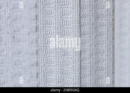 Defocused macro abstract texture background of a fabric vertical blinds surface in a gray white color Stock Photo
