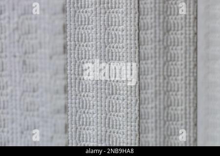 Defocused macro abstract texture background of a fabric vertical blinds surface in a gray white color Stock Photo