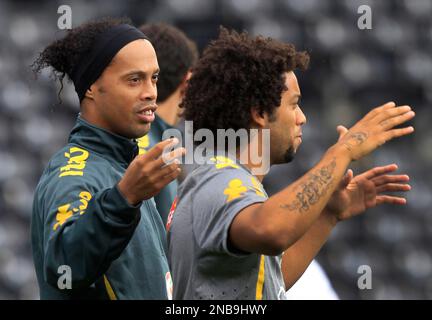 Brazil soccer squad s Ronaldinho left jokes with the hair of his teammate Marcelo during a training session at Fulham s Craven Cottage ground in London Sunday Sept. 4 2011 ahead of Monday s internatio...