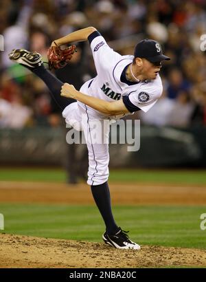 Seattle Mariners starting pitcher Charlie Furbush (41) talks with catcher  Chris Gimenez, right, after giving up a single to Texas Rangers' Josh  Hamilton in the third inning of a baseball game Sunday