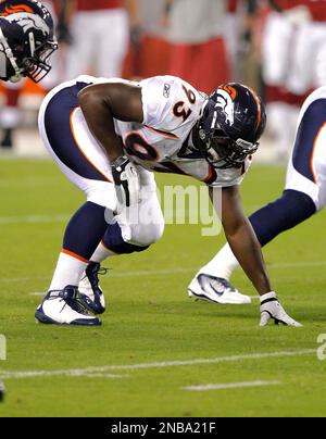 Denver Broncos defensive end Jeremy Mincey (57) wipes his face as