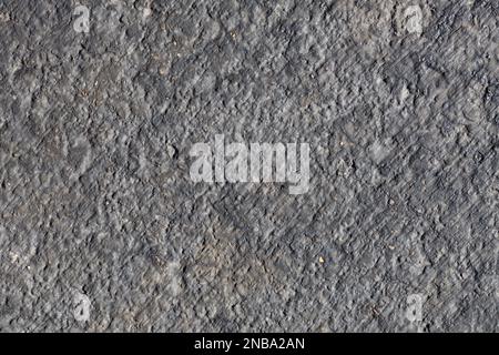 Full frame abstract texture background of an asphalt street surface, with natural texture and discoloration from weather and wear Stock Photo