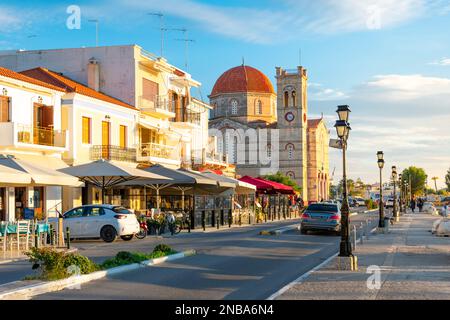 The old town waterfront harbor village of Aegina, Greece, with Saint Nicholas church in view on the Saronic Greek island of Aegina. Stock Photo
