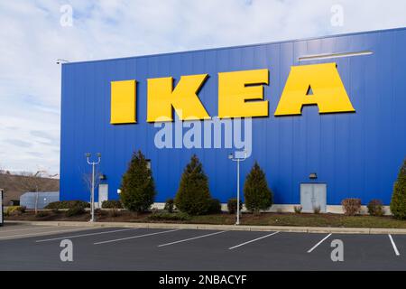 Renton, WA, USA - February 12, 2023; Yellow IKEA store name on blue wall of warehouse with parking Stock Photo