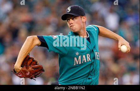 Seattle Mariners starting pitcher Charlie Furbush (41) talks with catcher  Chris Gimenez, right, after giving up a single to Texas Rangers' Josh  Hamilton in the third inning of a baseball game Sunday