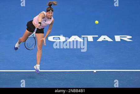 Doha, Qatar. 13th Feb, 2023. Karol¨ªna Muchova of the Czech Republic serves during the singles round of 32 match against Martina Trevisan of Italy at WTA500 Qatar Open 2023 in Doha, Qatar, Feb. 13, 2023. Credit: Nikku/Xinhua/Alamy Live News Stock Photo