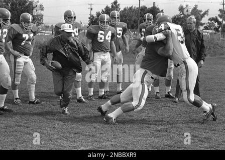 Coach Lou Saban of the Denver Broncos (with ball) runs his young charges  through a practice session in Denver, Colorado on August 25, 1967. Average  age of the Broncos is 23. Saban