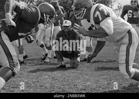 Coach Lou Saban of the AFL Denver Broncos inspects the play of two members  of his youthful team in Denver, Colorado on August 23, 1967. Average age of  the Broncos is 23