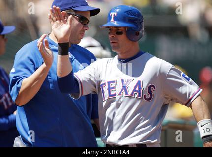 Texas Rangers Michael Young, right, is congratulated by teammate Josh  Hamilton after Young scored on a hit by Vladimir Guerrero in the third  inning against the Minnesota Twins during their baseball game