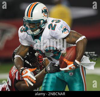 Miami Dolphins running back Kory Sheets (23) breaks the tackle of