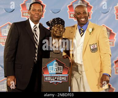 Deion Sanders, right, poses with his presenter, his agent Eugene Parker,  and a bust of himself during the induction ceremony at the Pro Football  Hall of Fame, Saturday, Aug. 6, 2011, in