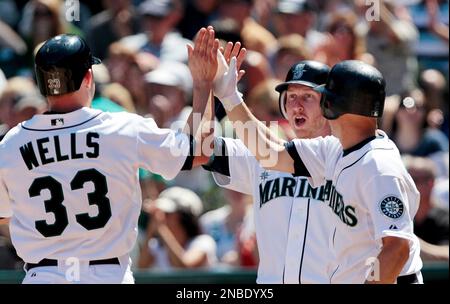 Seattle Mariners on-deck batter Franklin Gutierrez, left, watches