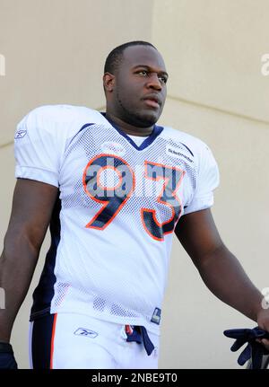 Denver Broncos defensive end Jeremy Mincey (57) wipes his face as