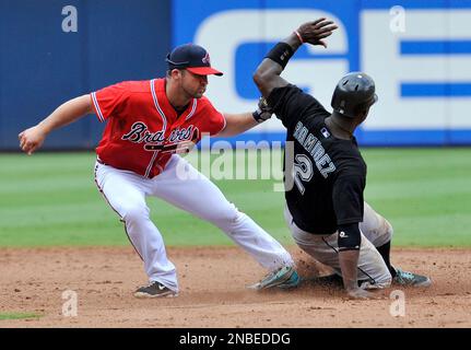 Los Angeles, USA. 8th June, 2013. Atlanta Braves second baseman Dan Uggla  #26 points as he crosses home after hitting a home run in the 5th inning  during the Major League Baseball