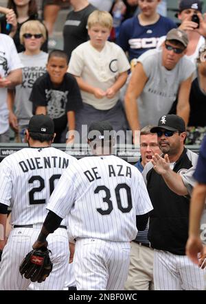 Chicago White Sox manager Ozzie Guillen, right, demonstrates a