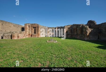 A nice area of lawn, grass in front of the ruins of the Sanctuary of Lari Pubblici, near the forum area. At Pompeii Archaeological Park near Naples, I Stock Photo