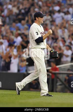 Minnesota Twins catcher Joe Mauer, left, and relief pitcher Joe Nathan  celebrate their 7-4 win over the Chicago Cubs after an interleague baseball  game, Friday, June 12, 2009 at Wrigley Field in