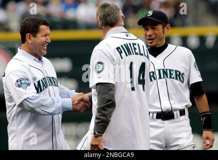 Former Seattle Mariners manager Lou Piniella (14) greets Mariners' Ichiro  Suzuki, right, and former Mariner Edgar Martinez prior to a baseball game  against the Texas Rangers, Saturday, July 16, 2011, in Seattle.