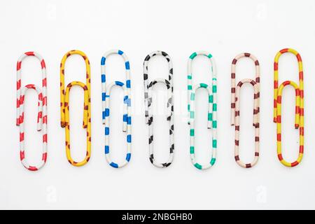 different colored paper clips isolated on white background Stock Photo