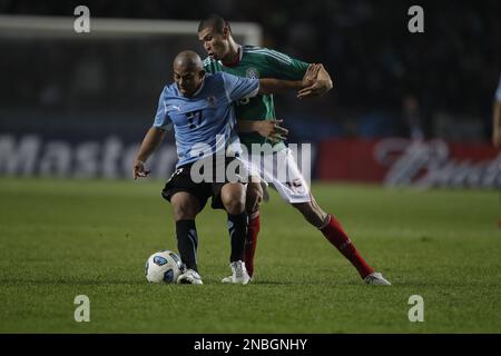 Uruguay's Egidio Arevalo Rios, left, and Mexico's Jorge Enriquez