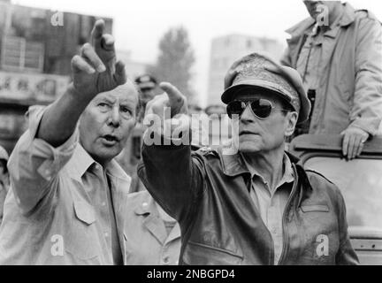 Director TERENCE YOUNG and LAURENCE OLIVIER (in costume as General Douglas MacArthur) on set location candid in 1979 during filming of INCHON 1981 director TERENCE YOUNG story Robin Moore and Paul Savage screenplay Robin Moore and Laird Koenig music Jerry Goldsmith One Way Productions / Unification Church / MGM-UA Entertainment Co. Stock Photo