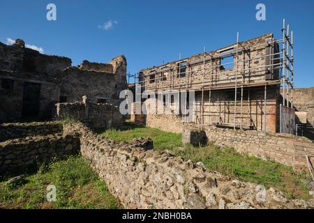 Preservation, restoration work with metal scaffolding being done at a large villa. At Pompeii Archaeological Park near Naples, Italy. Stock Photo