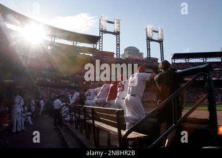 members of the St. Louis Cardinals stand for the National Anthem in their  1982 blue uniforms before a game against the Milwaukee Brewers at Busch  Stadium in St. Louis on August 5