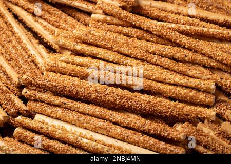 Pretzel bread sticks with sesame seeds. Delicious pretzels in bulk. close up Stock Photo