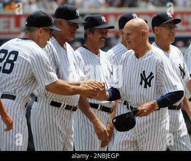 Former New York Yankees catcher Joe Girardi, right, shakes hands