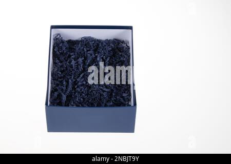 straw blue packing wood shavings chips fiber wooden thin paper open box carton Stock Photo