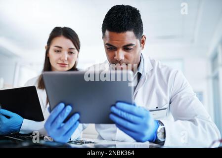 Theyve got the tools to backup their talent. a young man and woman using a digital tablet while repairing computer hardware in a laboratory. Stock Photo
