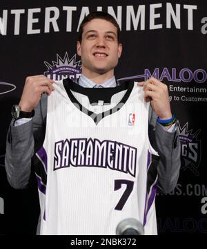 Jimmer Fredette the Sacramento Kings first round draft pick the 10th overall in the NBA draft held Thursday holds his jersey up during a news conference in Sacramento Calif. Saturday June 25