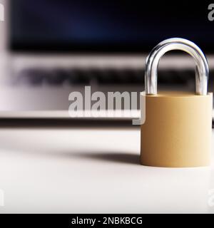 A Closeup of metal lock in front of laptop, concept of personal data protection Stock Photo