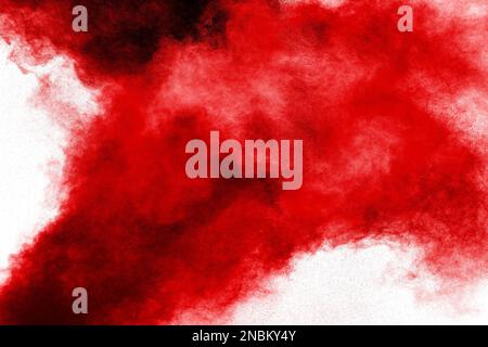 Red powder explosion cloud on white background. Freeze motion of red color dust  particles splashing. Stock Photo