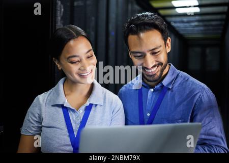 People, happy or laptop in server room, IT engineering or software programming for cybersecurity, analytics or database safety. Smile, man or data Stock Photo