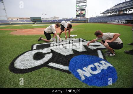 Members of the grounds crew paint the World Series logo on