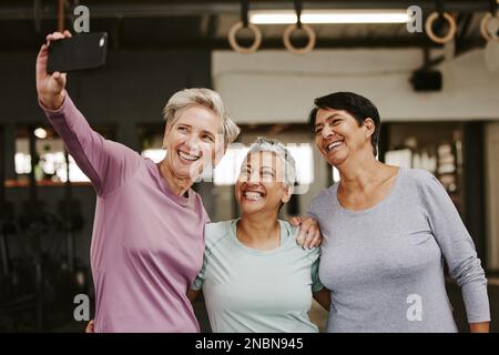 Selfie, friends and senior women in gym taking pictures for happy memory together. Sports, laughing and group of retired females taking photo for Stock Photo
