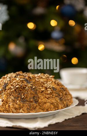 ant hill cake decorated with poppy seeds on a white plate. the concept of a festive tea party. Stock Photo