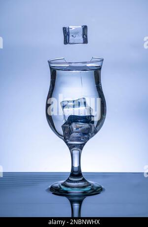 The image of pouring drinking water, into a broken glass, that makes one feel refreshed on blurred white background, Splashing water, Sparkling water, Stock Photo