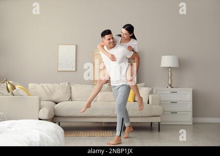 Happy couple in pyjamas having fun at home Stock Photo