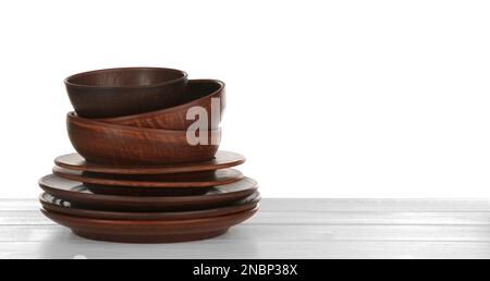 Different clay dishware on white wooden table Stock Photo