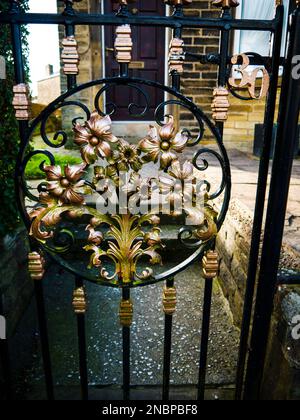 This gate is a triumph of the Blacksmith's art with its flowers so  beautifully made. It is a Work of Art Stock Photo
