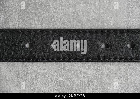 Black leather belt gray concrete background Stock Photo